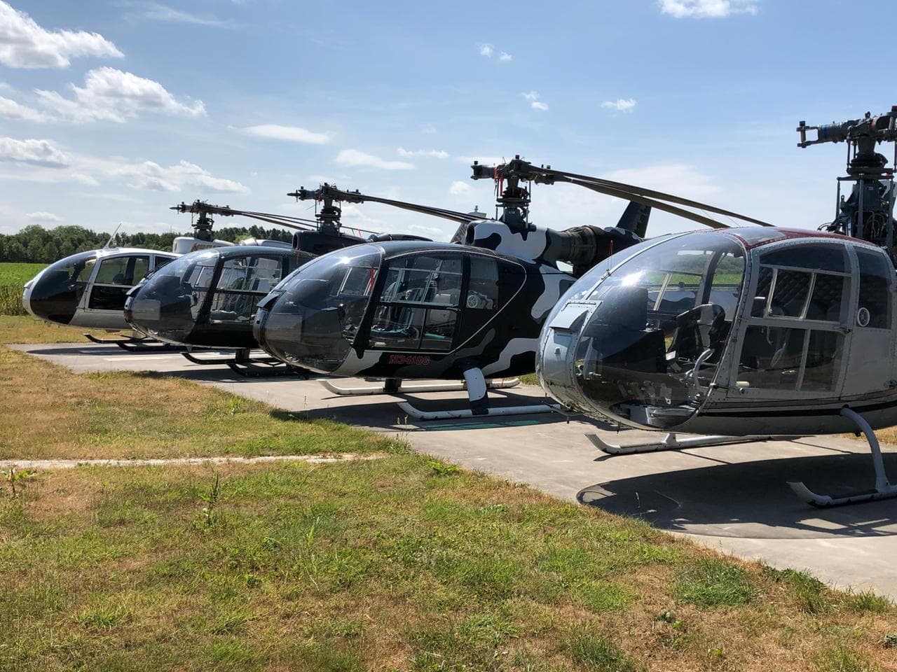 Four restored Gazelle helicopters lined up on the apron